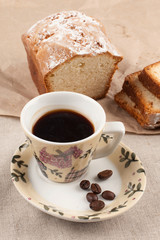 Cup with black coffee and muffin on linen background