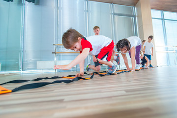Happy sporty children in gym. Kids exercises