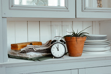 Time to Wake up! Vintage alarm clock on the shelf in the bedroom on home flowers background