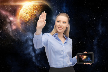 Fototapeta na wymiar business, future technology and people concept - smiling businesswoman with tablet pc computer or navigator and planet hologram over space background