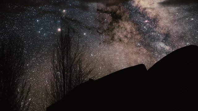 Timelapse Storm over Monument Valley rock reveals. Star Trails Galaxy Spins Behind the Rock. Milky Way Night Sky Wide Panorama. Timelapse Milky way over beach. Timelapse