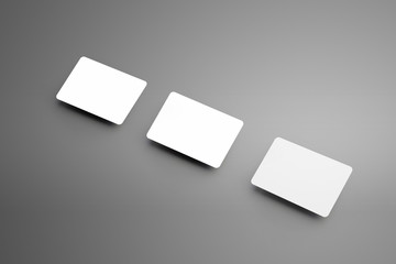 Stylish white mockup of a three bank (gift) card placed diagonally on a background.