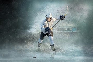 Fototapeta na wymiar Caucassian ice hockey Players in dynamic action in a professiona