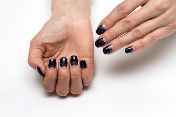 purple, black lunar manicure with silver sequins on all nails on a quadrature form on a white background

