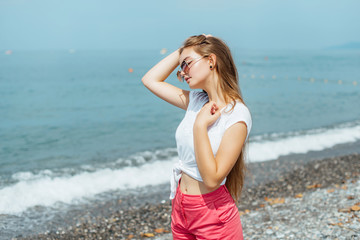 Fototapeta na wymiar Fashion Portrait of Beautiful Girl. Posing on Beach at Europe. 