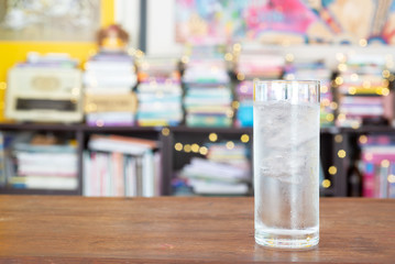 a glass of cold water on wooden table