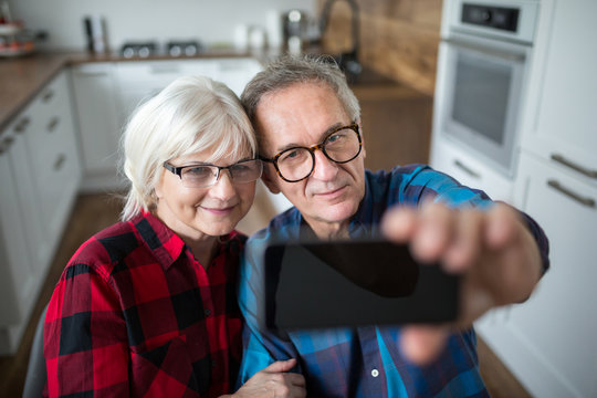 Happy Senior Couple Taking Selfie By Smartphone