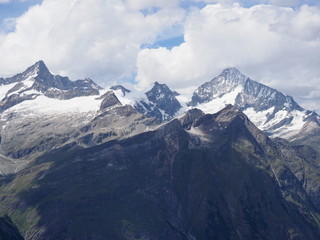 Panorama of alpine mountains range in swiss Alps seen from Gornergrat at SWITZERLAND, cloudy sky in 2017 warm sunny summer day on July.