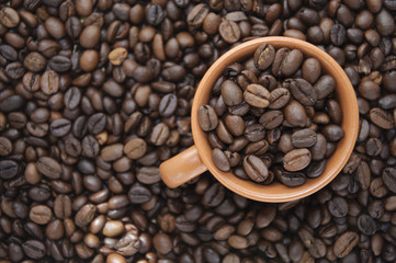 Cup full of coffee beans with copy space