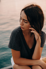 Fashion Portrait of Beautiful Sexy Girl. Posing on Yacht Club at Europe. Young Pretty Hipster Woman with Long Dark Brown Hair Color, Big Lips and Sunglasses. Film Color, Grain and Effects 