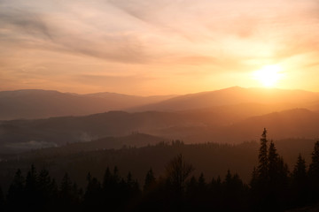 A lovely colorful orange sunset in the summer mountains