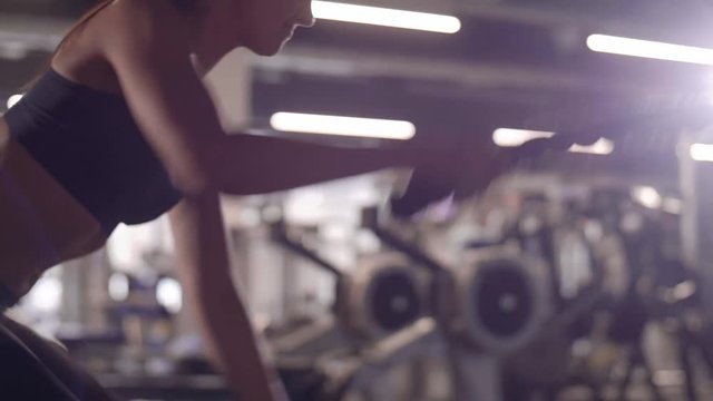 Athlete training with ropes at gym 