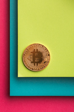 Overhead view of bitcoin on colorful background