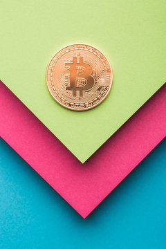 Overhead view of bitcoin on colorful background