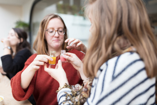 Friends trying out healthy juices in bar