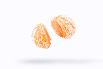 Mandarin in flight burst on a white background, isolated. Cut half Mandarin flying in the air. Mandarin fruit explosion