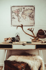 close up view of table with map, magnifying glasses and various decorations