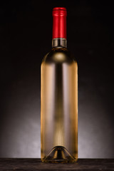 single bottle of luxury white wine on black