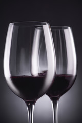 close-up shot of glasses of delicious red wine on black