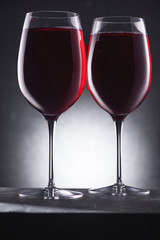 close-up shot of glasses full of delicious red wine on black