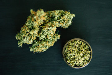 Macro of cannabis bud marijuana weed and grinder with trichomes top view
