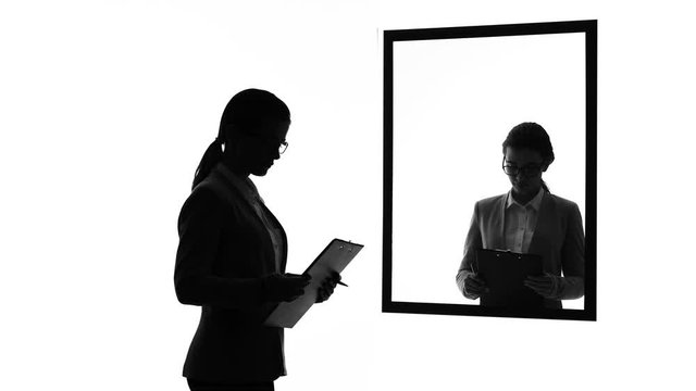 Business woman looking in mirror, dreams of having boyfriend, life priorities