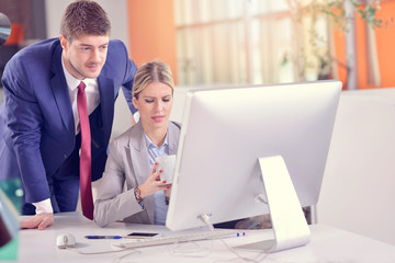 Business couple working together on project at modern startup office
