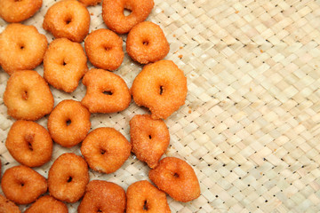 Deep frying medu vada in the pan. Medu Vada is a savoury snack from South India, very common street food in the India.