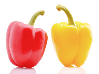 Red and yellow sweet peppers on white background