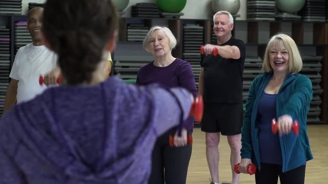Small group of people exercising with hand weights