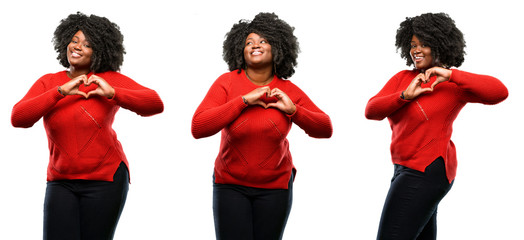 Young beautiful african plus size model happy showing love with hands in heart shape expressing...