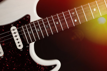 Obraz premium Live music. Modern electric guitar close-up with stage lights