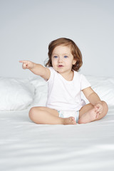 Fototapeta premium Girl in pajamas pointing at copy space