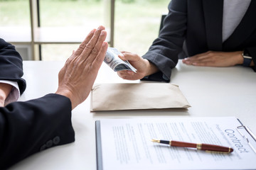 Bribery and corruption concept, senior businessman manager refusing receive money in the envelope...