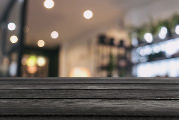 Empty wooden table and blurred background of abstract in front of restaurant or coffee shop for display of product or for montage