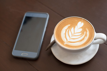coffee cup latte art. Hot coffee cappuccino latte art. A Cup of hot latte art coffee on wooden table, 