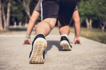 Fototapeta na wymiar Close up on shoes, athlete runner feet running on track to begin starting