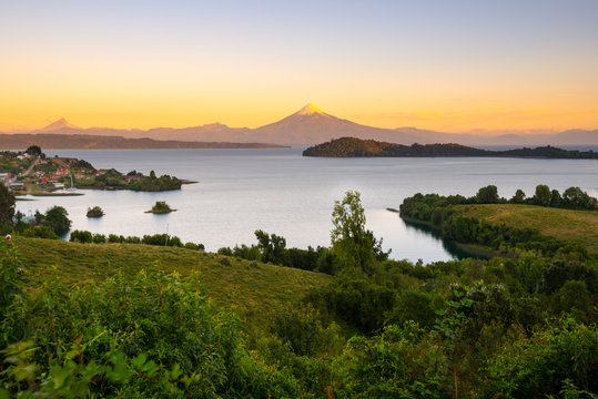 View of Puerto Octay at the shores of Lake Llanquihue, with Osorno Volcano and Puntiagudo Volcano in the back, X Region de Los Lagos, Chile