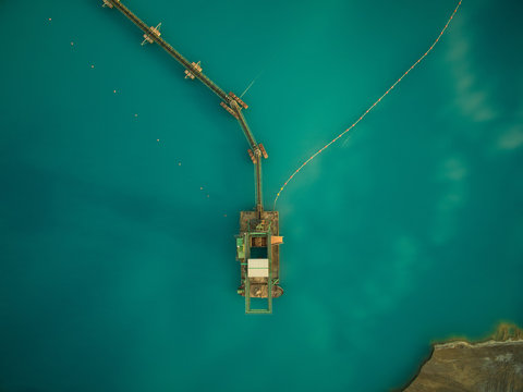 aerial view of sand dredge in blue lake