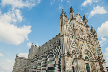 Fototapeta na wymiar low angle view of ancient Orvieto Cathedral against blue sky in Orvieto, Rome suburb, Italy