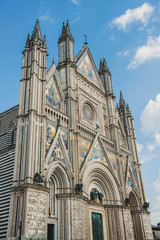 Fototapeta na wymiar low angle view of old Orvieto Cathedral against blue sky in Orvieto, Rome suburb, Italy
