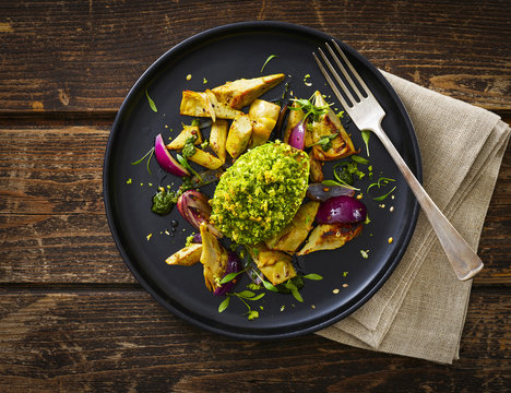 Filled and gratinated avocado with egg and artichoke