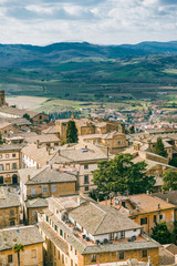 Fototapeta na wymiar aerial view of buildings and hills on background in Orvieto, Rome suburb, Italy