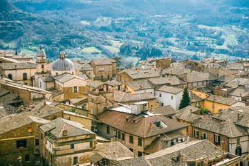 Fototapeta na wymiar aerial view of buildings and hills with trees in Orvieto, Rome suburb, Italy