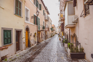 Naklejka premium narrow street with buildings in Castel Gandolfo, Rome suburb, Italy