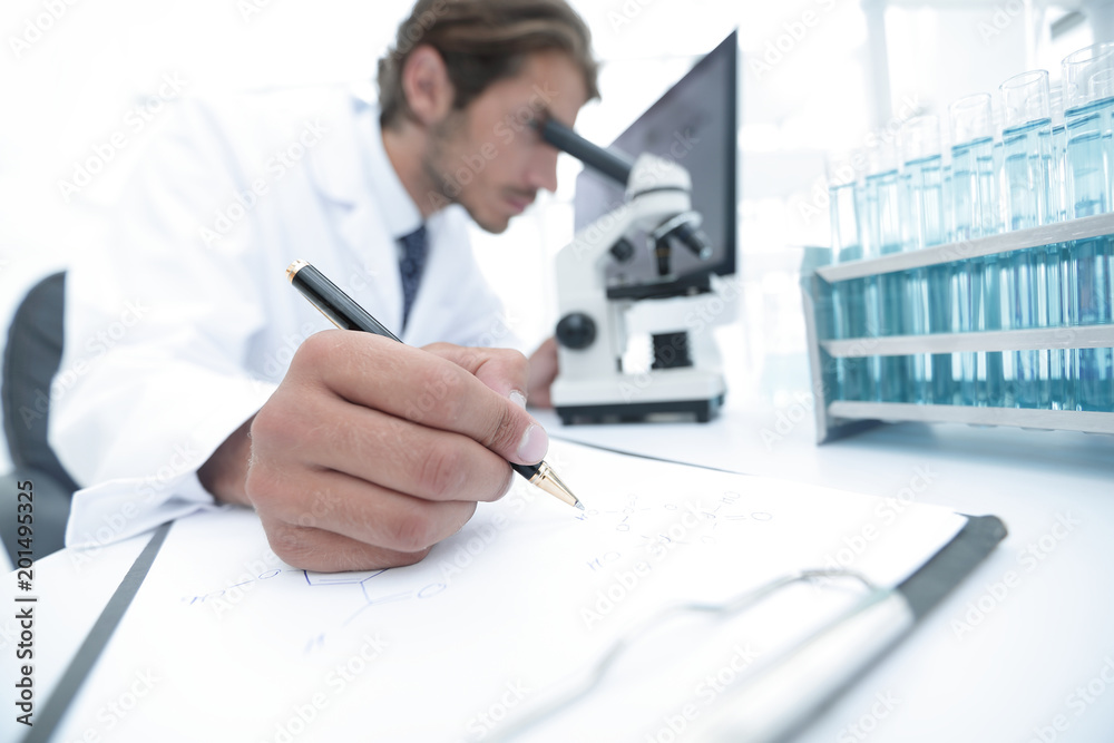 Wall mural scientist makes a note of experiment in the laboratory