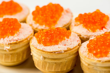 Tartlets with cheese and red caviar. Selective focus. Copy space