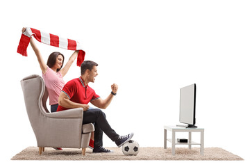 Euphoric soccer fans watching football on television