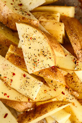raw potato slices with spices in a baking dish