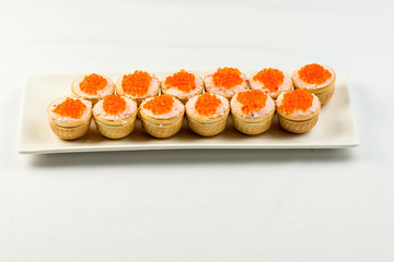 Tartlets with cheese and red caviar. Selective focus. Copy space